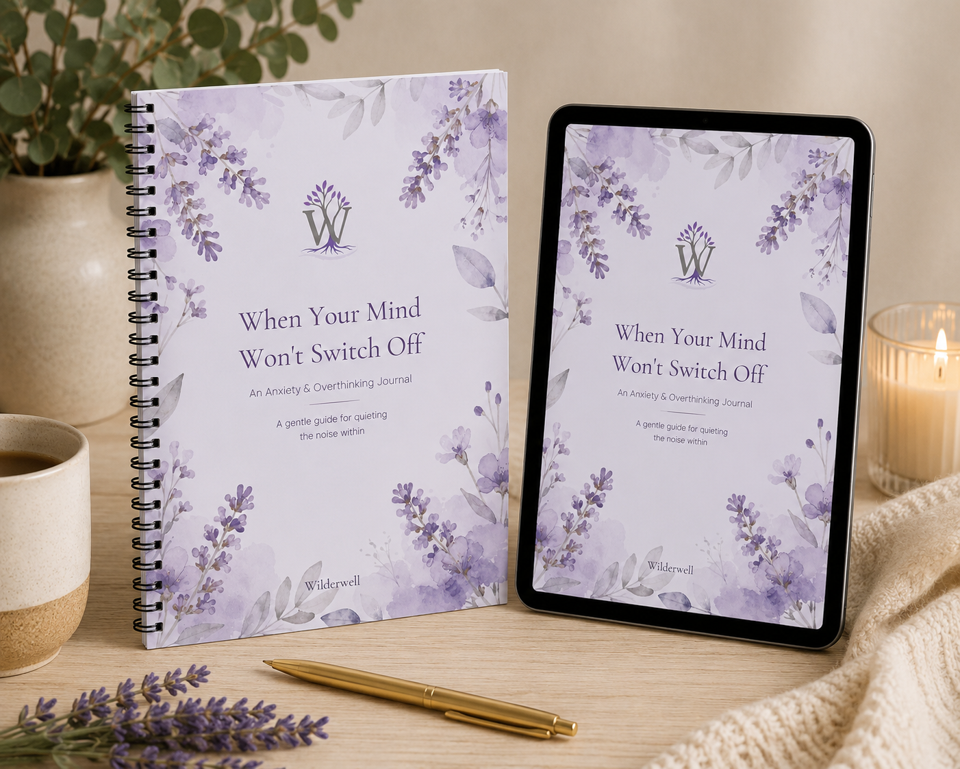 A spiral-bound journal and a tablet displaying the same cover design, both featuring a lavender floral design and the title 'When Your Mind Won't Switch Off.' The scene is styled on a wooden surface with a mug, candle, pen, and knit fabric in a cozy indoor setting.