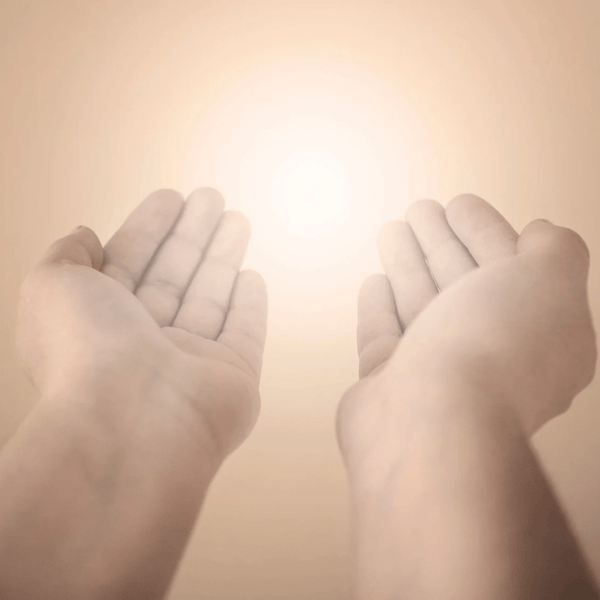 Two pairs of hands held open against a warm beige background