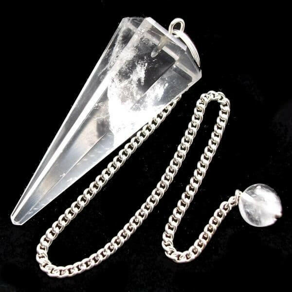 Crystal pendulum with chain on a black background